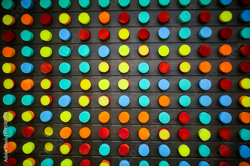 Wall with colorful rounds in the entertainment center. Mosaic from foam for kids. Happy family time playing.