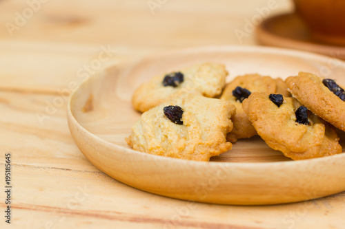 cookies with raisins on round plate and brown wooden table
