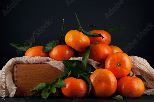 fresh ripe tangerines  rustic food photography on slate plate kitchen table can be used as background