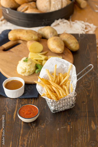 French fries with ketchup on wooden background