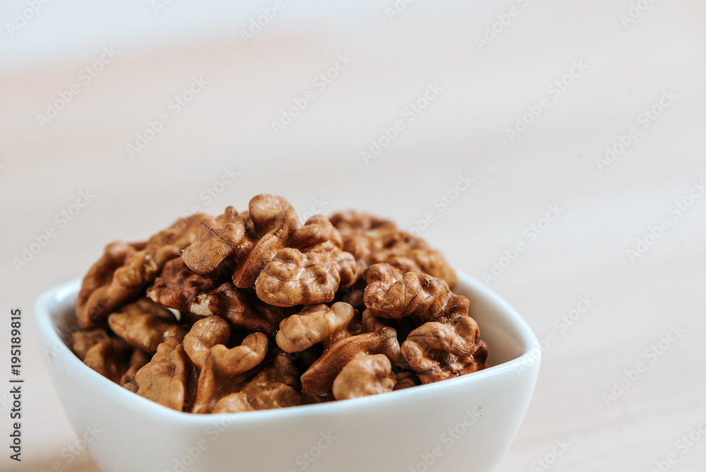 Close-up image of white bowl with walnuts. Copy space. Close-up image of white bowl with walnuts. Copy space.