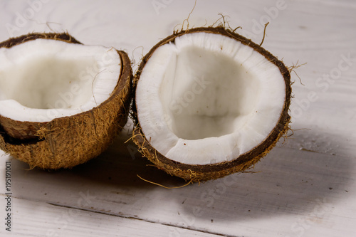 Fresh ripe coconut on white wooden table