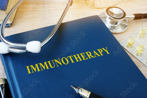Book with name immunotherapy and stethoscope. photo