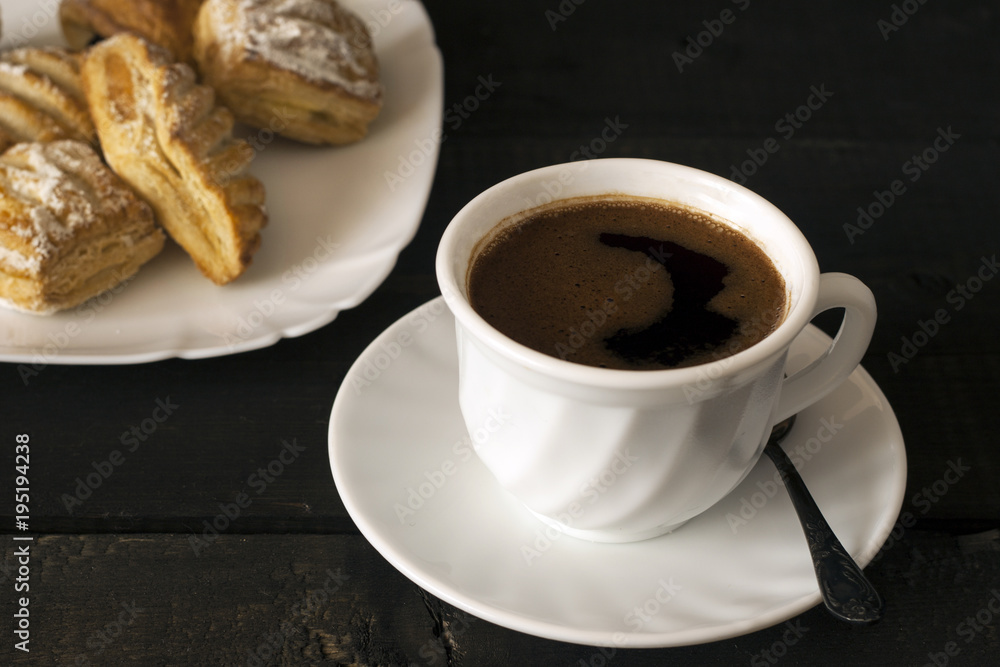 Cup of hot coffee and cookies for breakfast on wooden table Cup of hot coffee and cookies for breakfast on wooden table