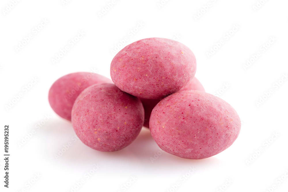 Heap of pink sugared almonds dragees isolated on white background Heap of pink sugared almonds dragees isolated on white background