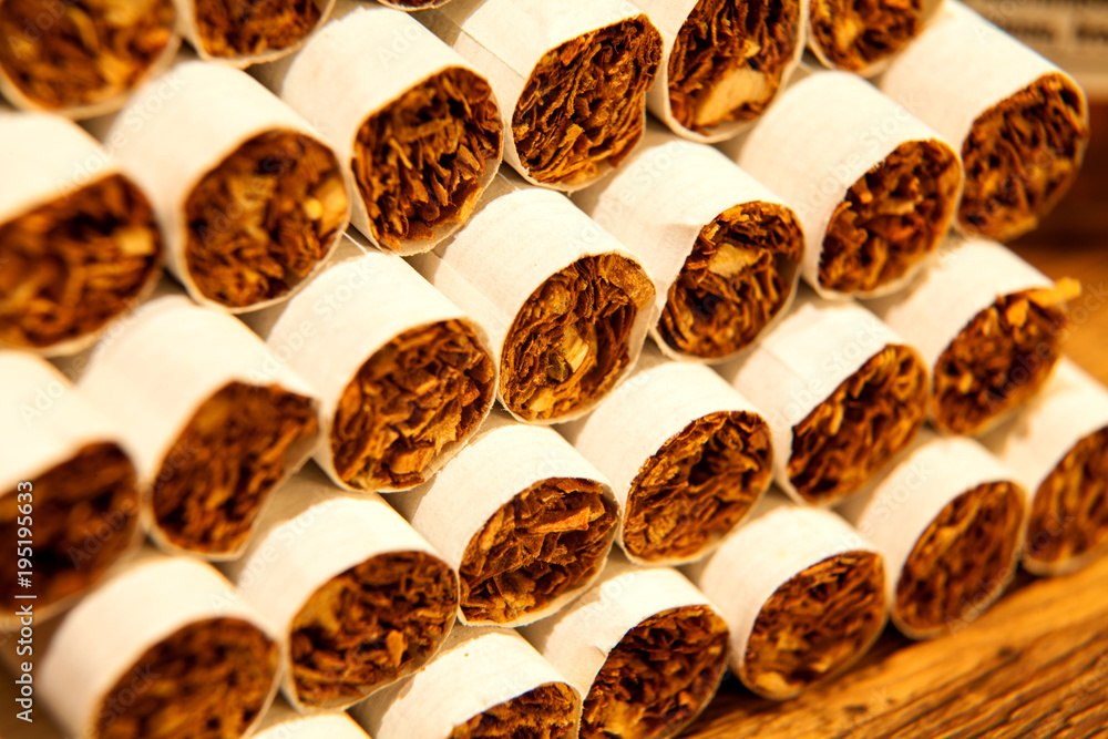 Heap of Tobacco Cigarettes, stack as a background texture close up Heap of Tobacco Cigarettes, stack as a background texture close up
