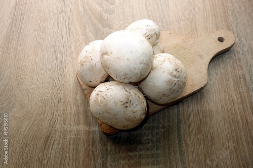 Champignon mushrooms on wooden background
