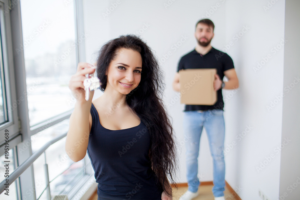 Moving day. Happy young couple carrying boxes Moving day. Happy young couple carrying boxes