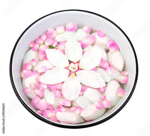 spa procedure, floral arrangement, harmony concept. there are white petals that are floating on the surface of the clean water in basin, they compose a circle and look like flower from top view