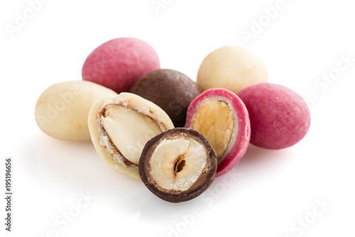 Heap of sugared almonds and hazelnuts dragees in chocolate isolated on white background