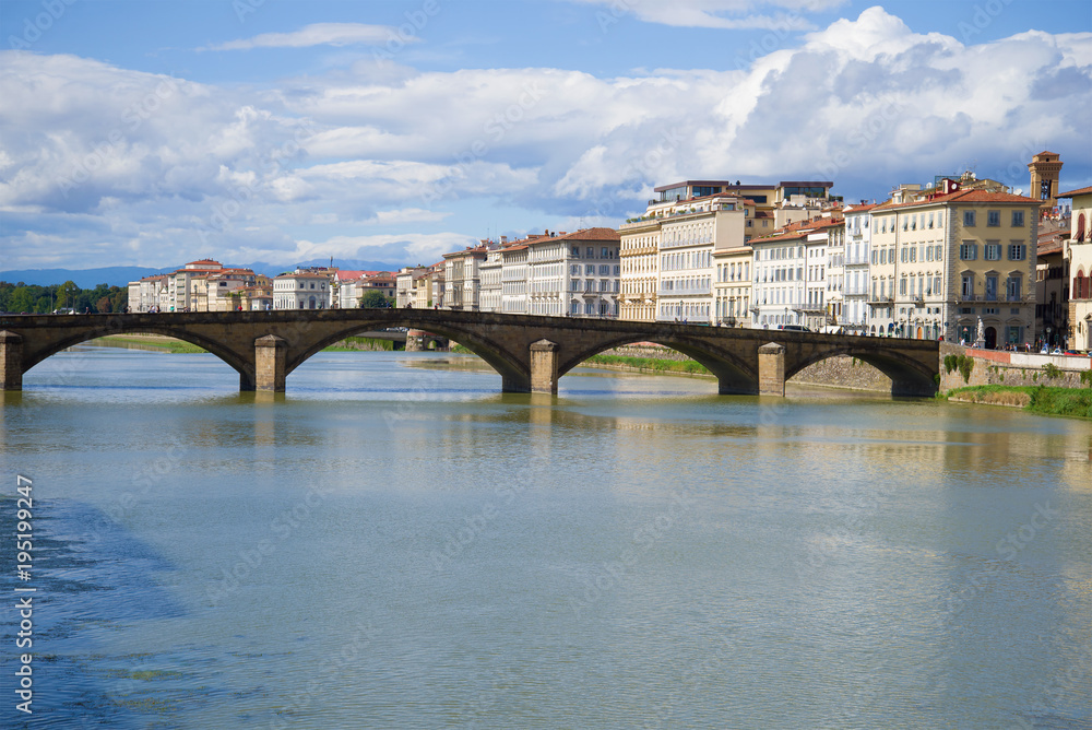 Ponte alla Carraia and the city embankment on a sunny day. Florence, Italy