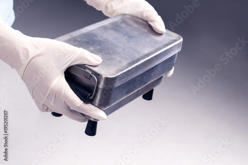 Sterile box for tools, female hands holding a sterile box