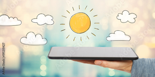 Sunny Day with man holding a tablet computer