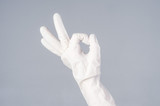 Male hand in latex glove. OK sign. on dark background