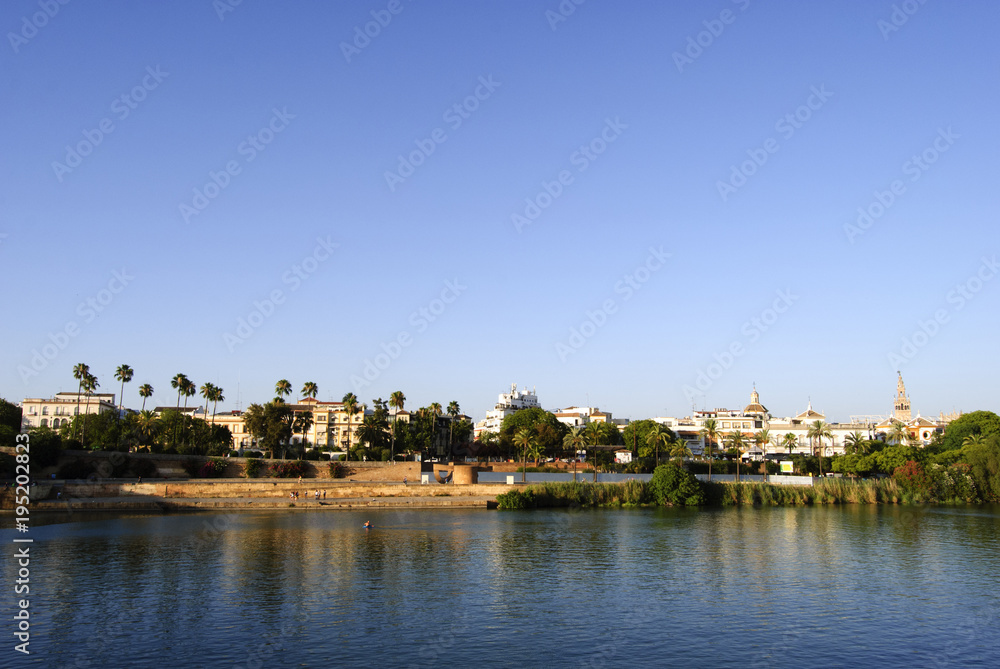 Panoramic view of Seville riverbank with La Giralda in the background
