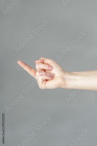 Woman hand showing middle finger on a white isolated background