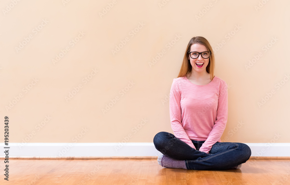 Happy young woman smiling in a big open room