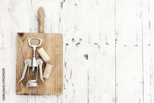 Wine corkscrew  on vintage white wooden background, copyspsce. Wine tasting concept. © nataliazakharova