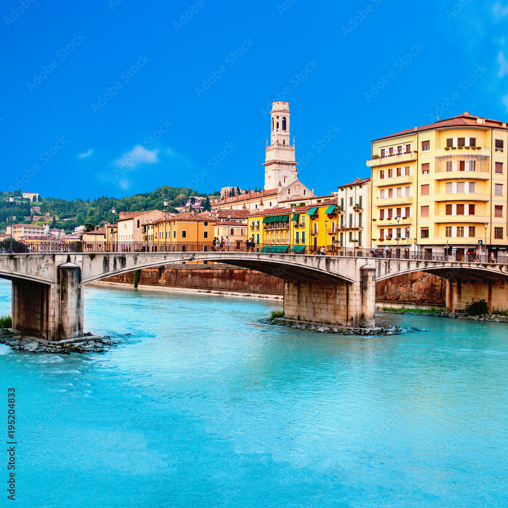 Verona, Italy. Scenery with Adige River and Ponte di Pietra at summer day with blue sky. Panorama. Ancient european Italian city