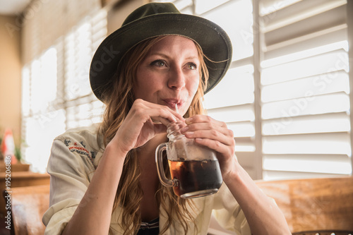 close up of girl drinking a soda pop