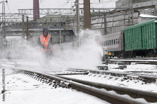 Cleaning of Railroad switch, in railway transport, from snow. photo