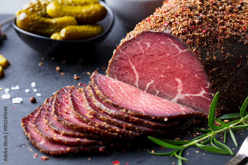 Roasted beef, pastrami on slate cutting board. Close up. StockFoto