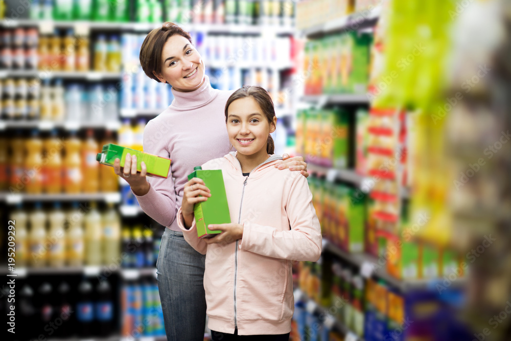 Woman customer with girl looking for refreshing beverages