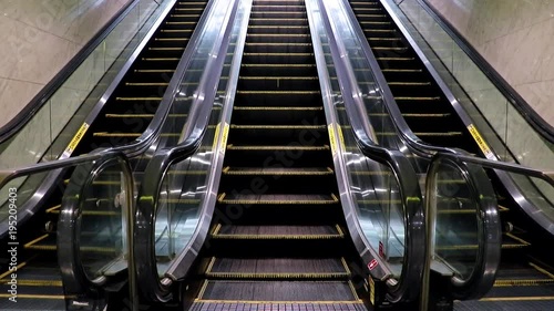 Empty escalator from the metro station. Exit of the subway on the moving stairs.
