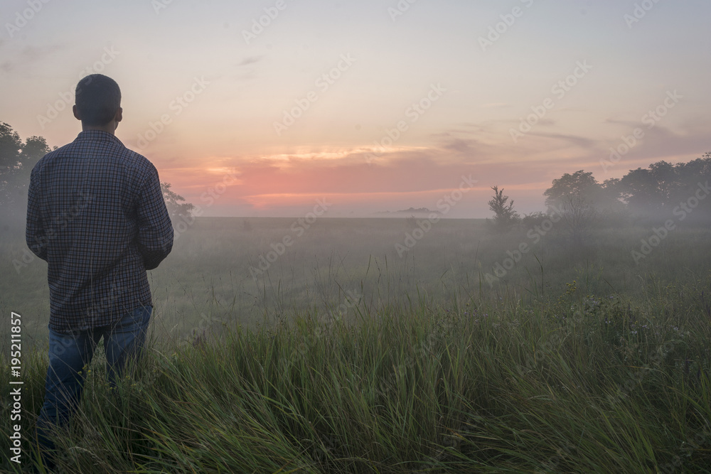 the guy stands in the fog in the field