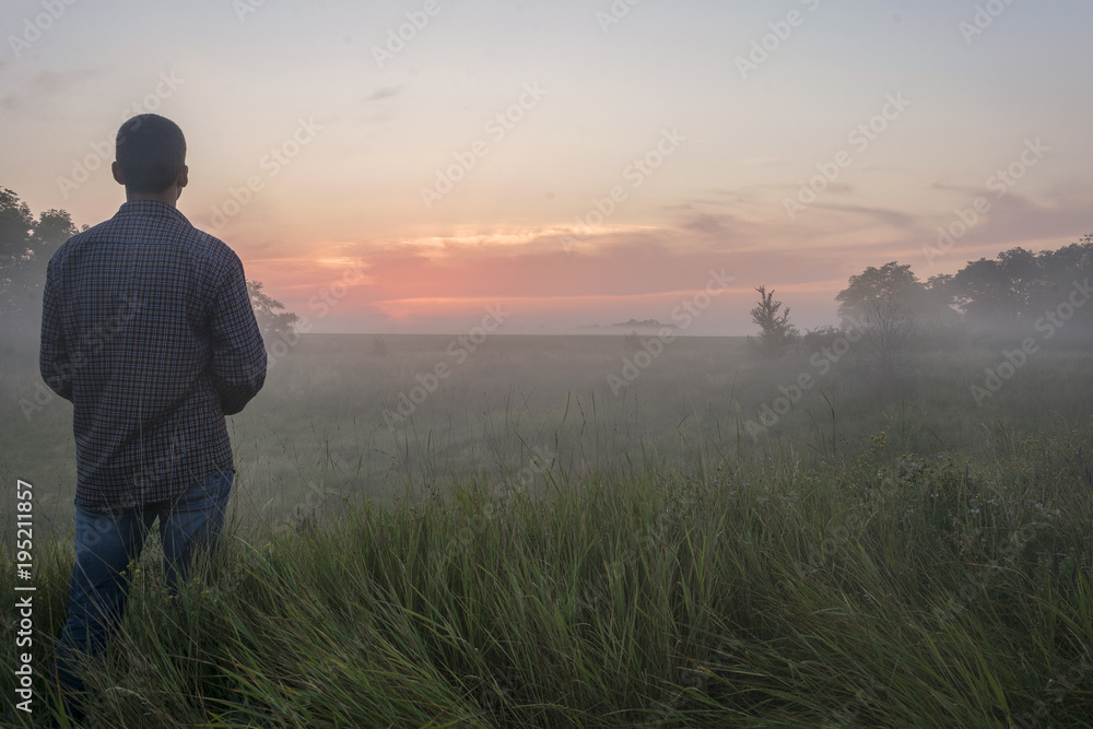 the guy stands in the fog in the field the guy stands in the fog in the field