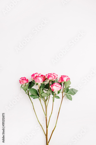 Pink rose flowers bouquet on white background. Flat lay  top view. Minimal spring floral concept.