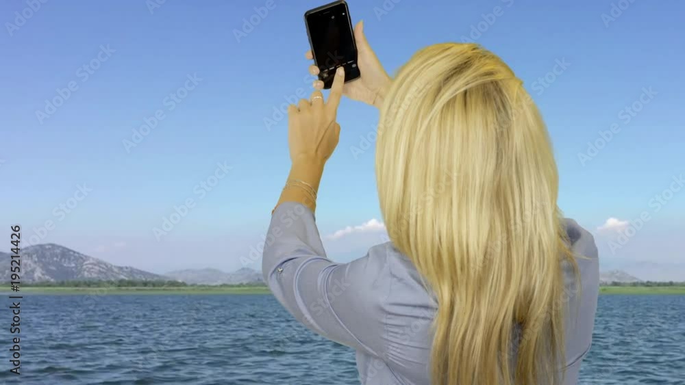 Attractive woman taking selfie photo on mobile during floating on sea yacht Attractive woman taking selfie photo on mobile during floating on sea yacht