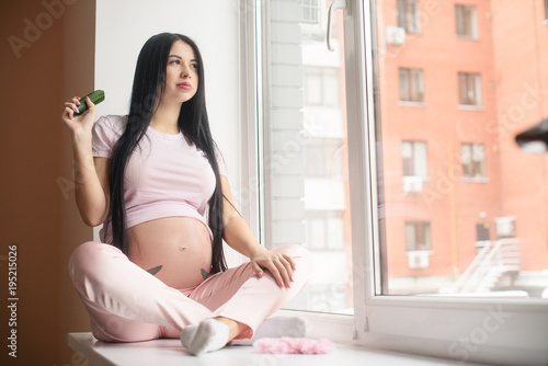 Free Download Pregnant woman eating fresh cucumber - GFXLoad