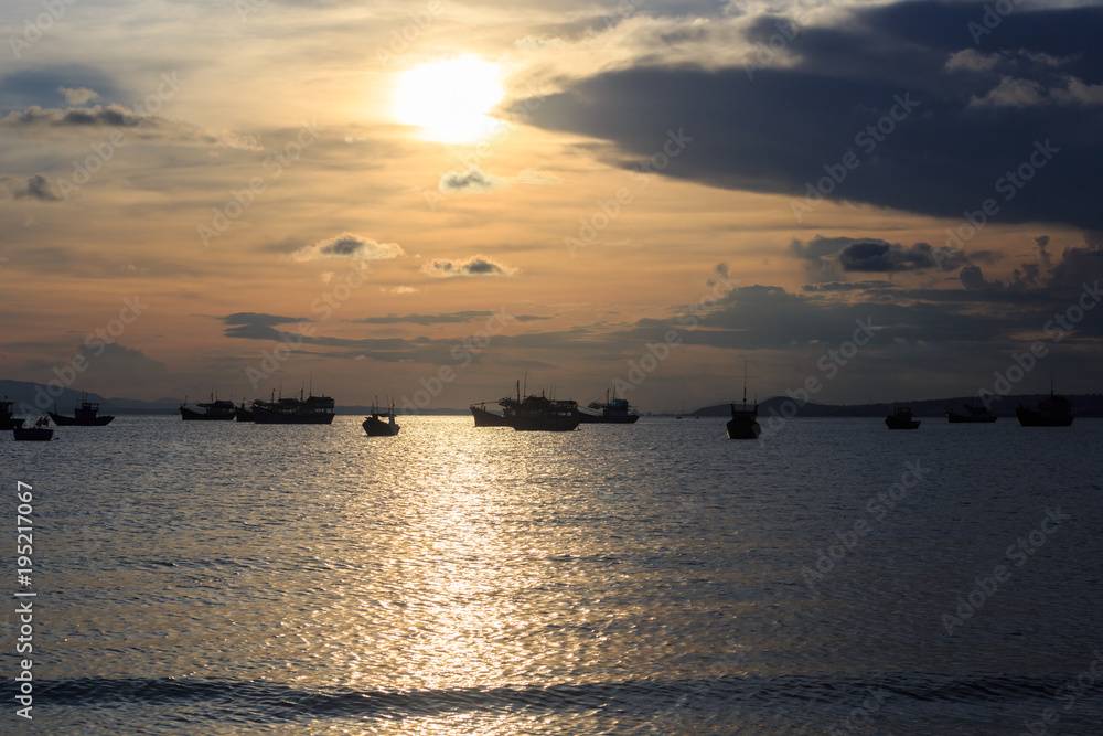 Vietnamese fishing boat silhouettes in sea at sunset Vietnamese fishing boat silhouettes in sea at sunset
