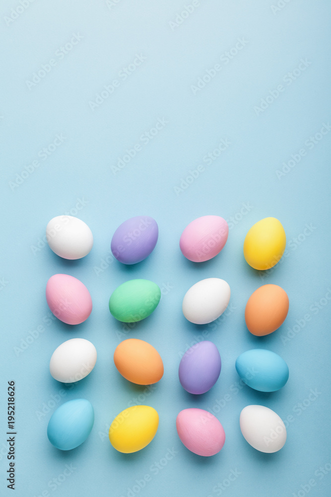Creative Easter pattern made of colorful eggs painted in pastel colors. Flat lay. Easter concept.