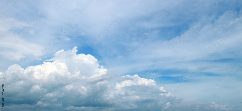 Light clouds in the blue sky. Wide photo.