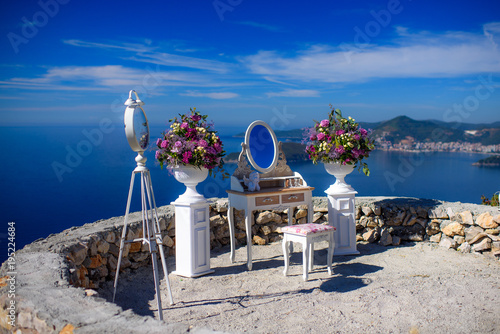 boudoir table with flowers and a mirror