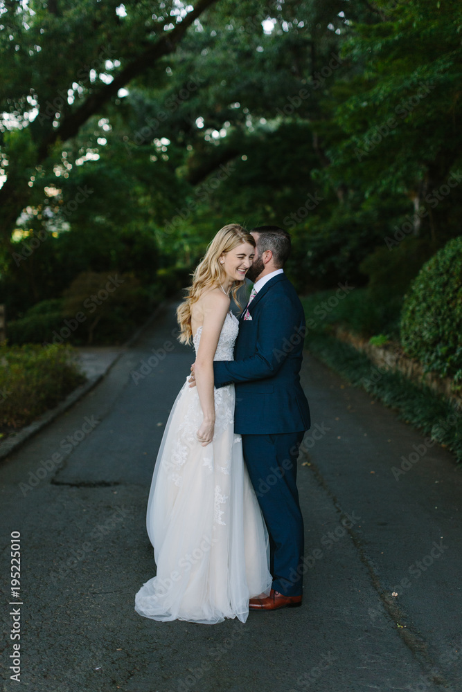 Groom Whispering Something in Wife's Ear