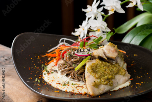 Grilled sea bass fillet with ginger, almonds, lime sauce with Japanese soba noodles