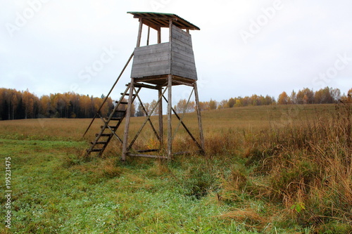 Biotechnical structure intended for hunting and watching wild animals, against the backdrop of autumn nature. © jakov