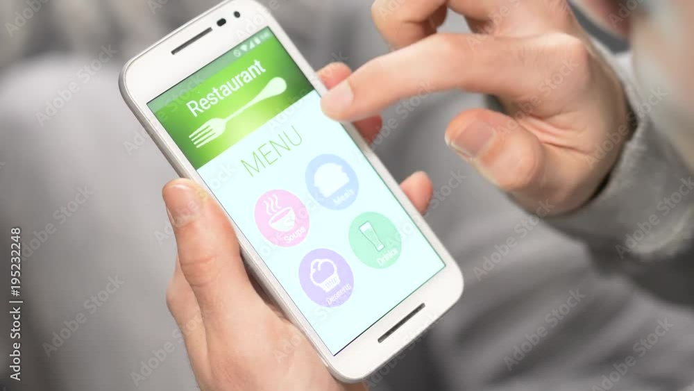 Online restaurant menu showing on a smartphone. User is browsing the different soups available to order. Online restaurant menu showing on a smartphone. User is browsing the different soups available to order.