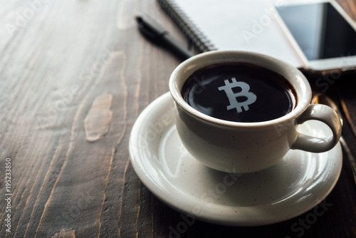 Bitcoin symbol on top of coffee surface