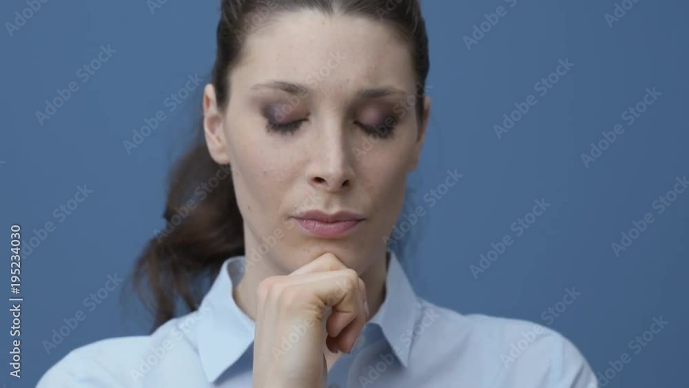 Woman thinking with hand on chin and smiling Woman thinking with hand on chin and smiling