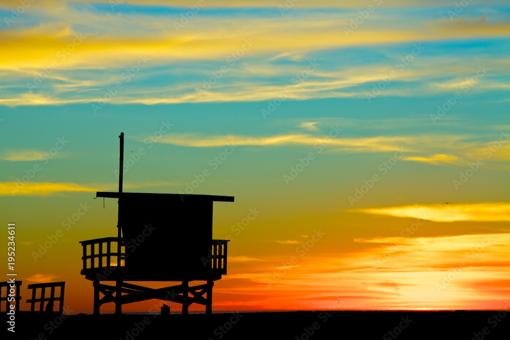 Silhouette of a lifeguard stand against a colorful sunset Silhouette of a lifeguard stand against a colorful sunset