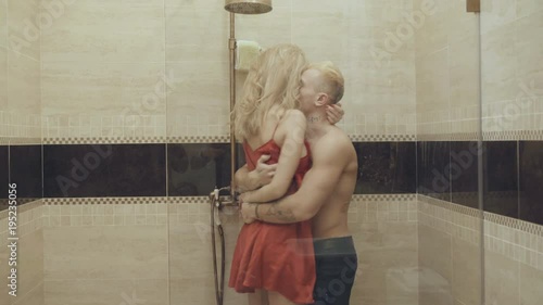 Happy passionate lovers caressing and kissing in shower cabin