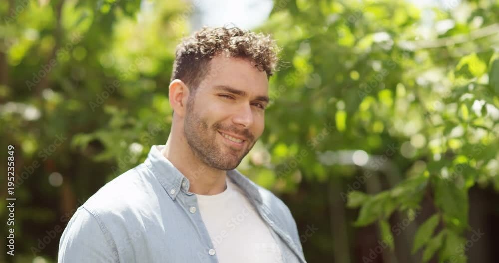4K Portrait happy man smiling to camera, standing in green natural environment. Slow motion. 4K Portrait happy man smiling to camera, standing in green natural environment. Slow motion.