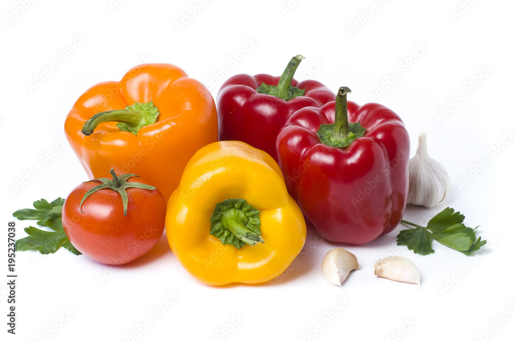 Red yellow and orange peppers on a white background..Multicolored vegetables in a composition on an abel background. Red yellow and orange peppers on a white background..Multicolored vegetables in a composition on an abel background.