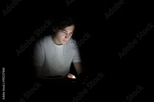 Young caucasian man reading working with smartphone at 