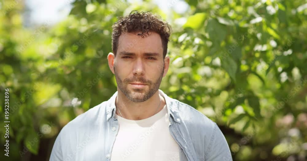 4K Portrait happy man smiling to camera, standing in the garden at home. Slow motion. 4K Portrait happy man smiling to camera, standing in the garden at home. Slow motion.