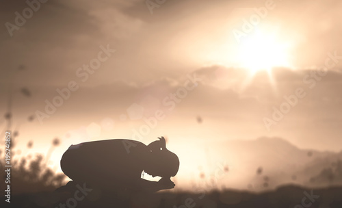 Tela Easter Sunday concept: Silhouette of prayer woman kneeling and praying over autu